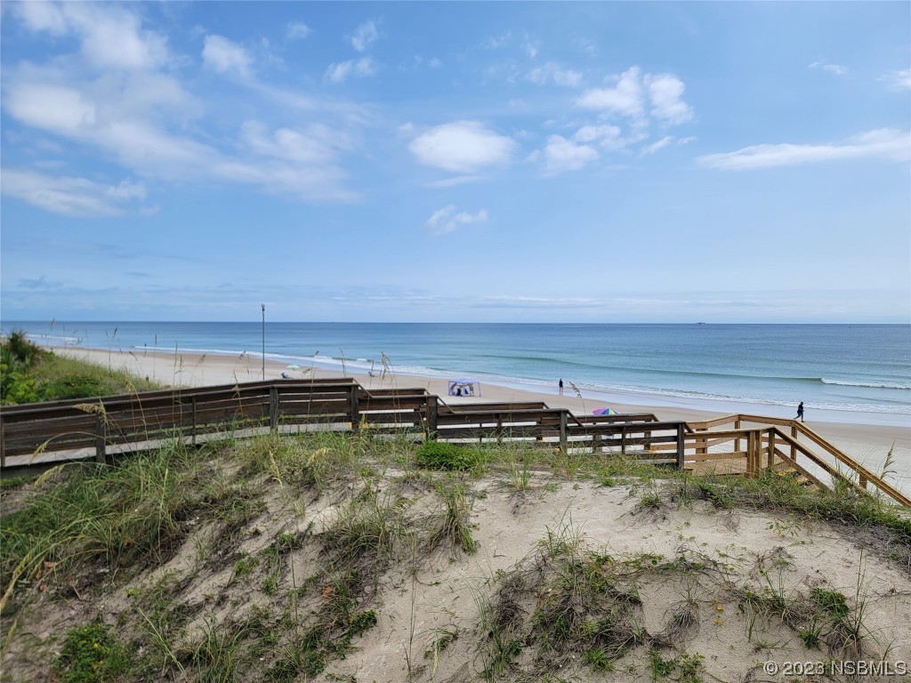 4623 Rivers Edge Village Lane, Unit 6204 Ponce Inlet, FL 32127 - Photo 34 of 62 a view of a swimming pool with an outdoor seating and a forest