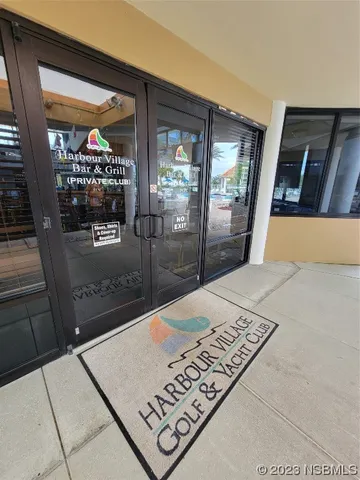 a view of balcony with a couple of cars parked in parking lot