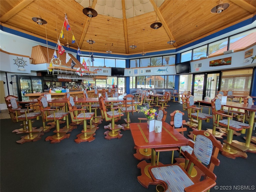 4623 Rivers Edge Village Lane, Unit 6204 Ponce Inlet, FL 32127 - Photo 42 of 62 a group of people sitting in front of retail shop