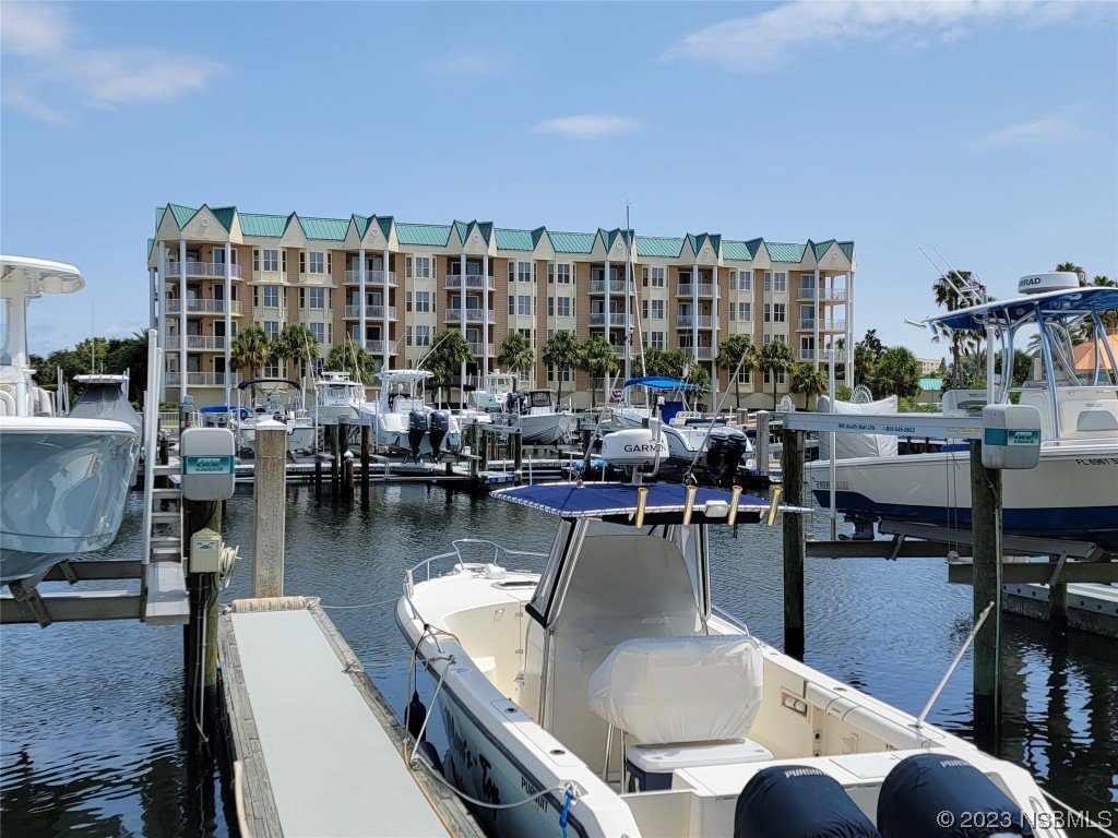 4623 Rivers Edge Village Lane, Unit 6204 Ponce Inlet, FL 32127 - Photo 48 of 62 a outdoor dining space with furniture and a view of lake