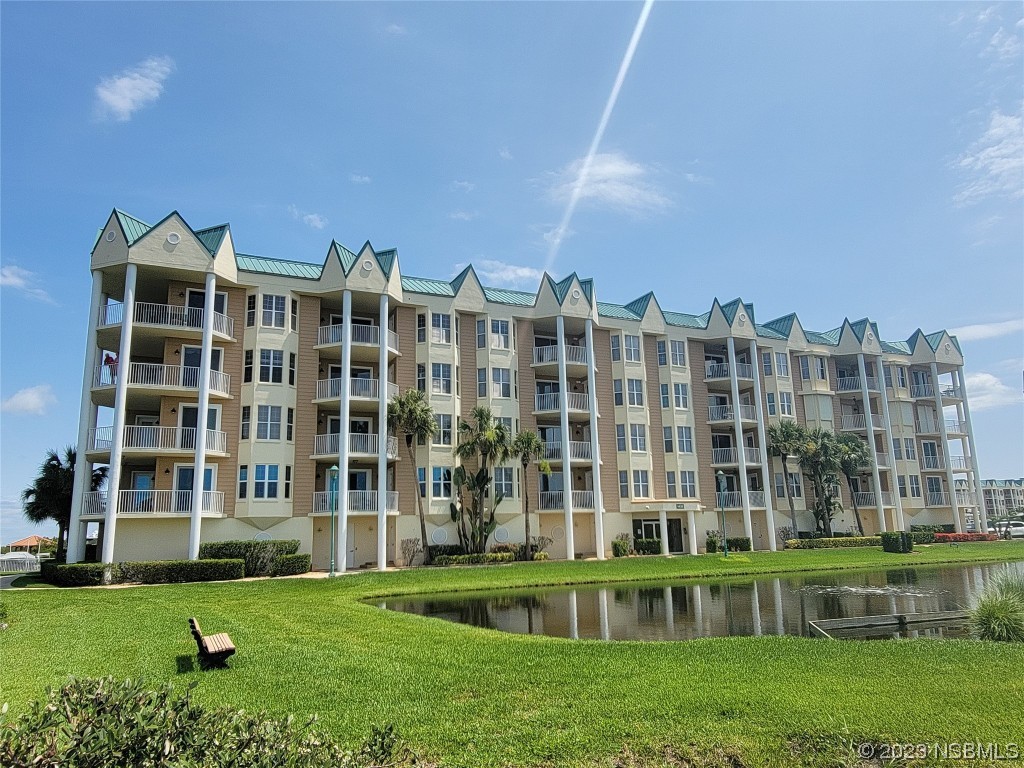 4623 Rivers Edge Village Lane, Unit 6204 Ponce Inlet, FL 32127 - Photo 51 of 62 a view of building with a yard