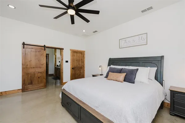 a spacious bedroom with a bed and a window