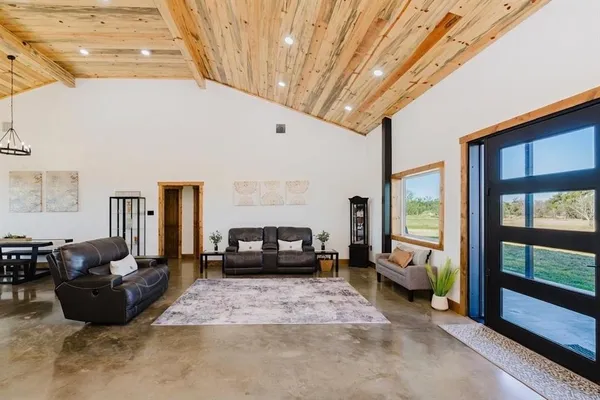 a living room with furniture and a chandelier