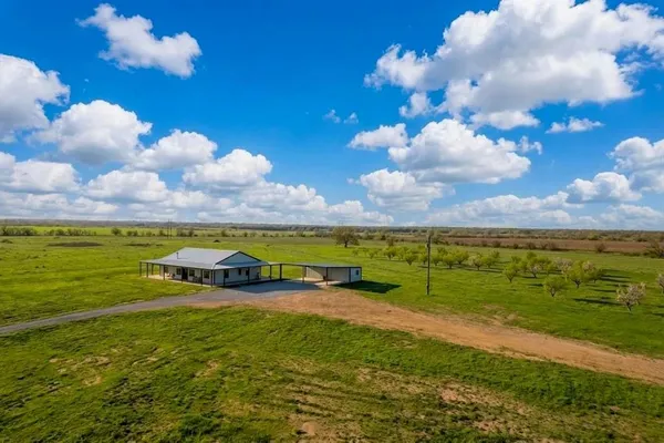 a view of a big yard with lots of green space