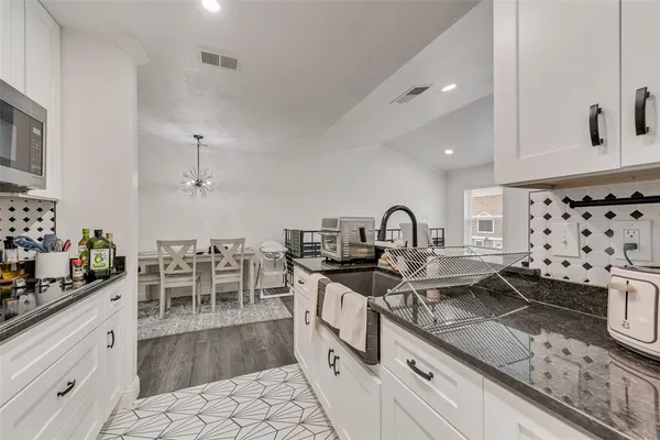a kitchen with lots of counter top space and dining table