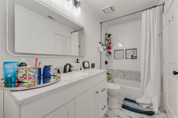 a bathroom with a sink a toilet and a shower