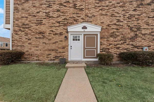a view of a brick house with a large windows