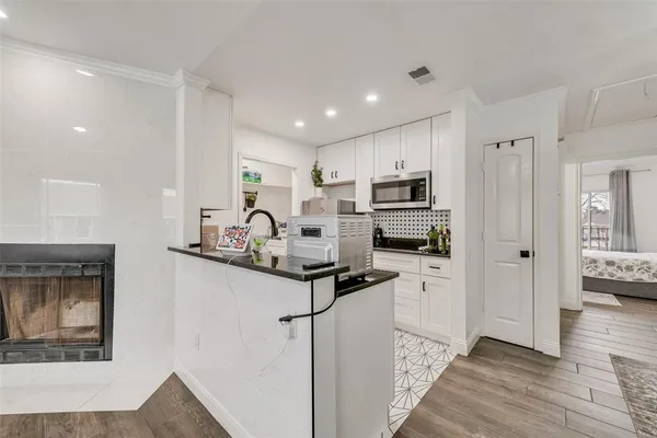 a kitchen with granite countertop a refrigerator stove and sink