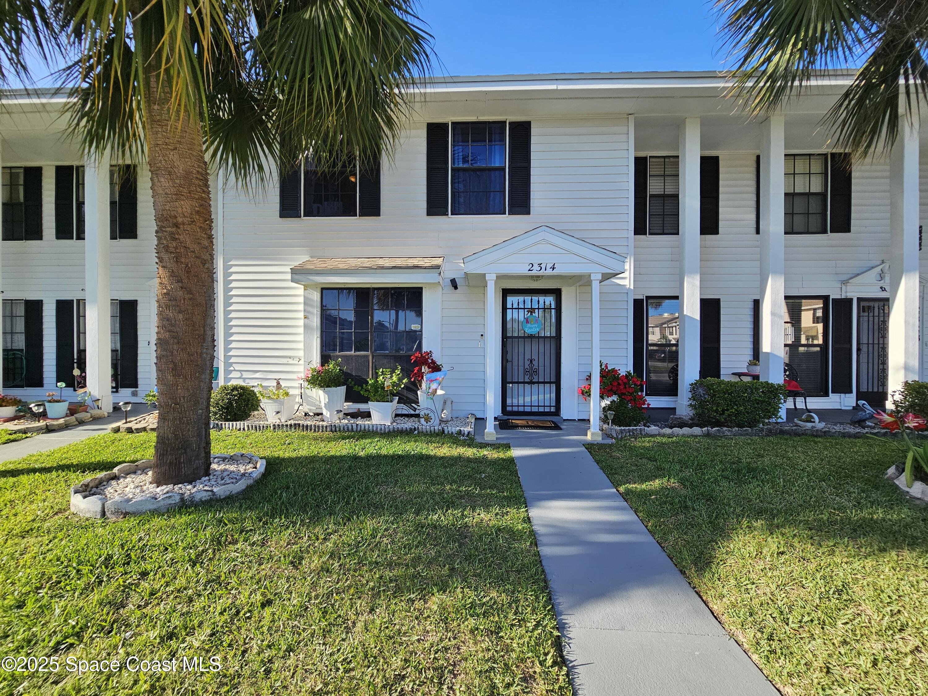 2314 Manor Drive Northeast Palm Bay, FL 32905 - Photo 1 of 23 a front view of house with yard and green space