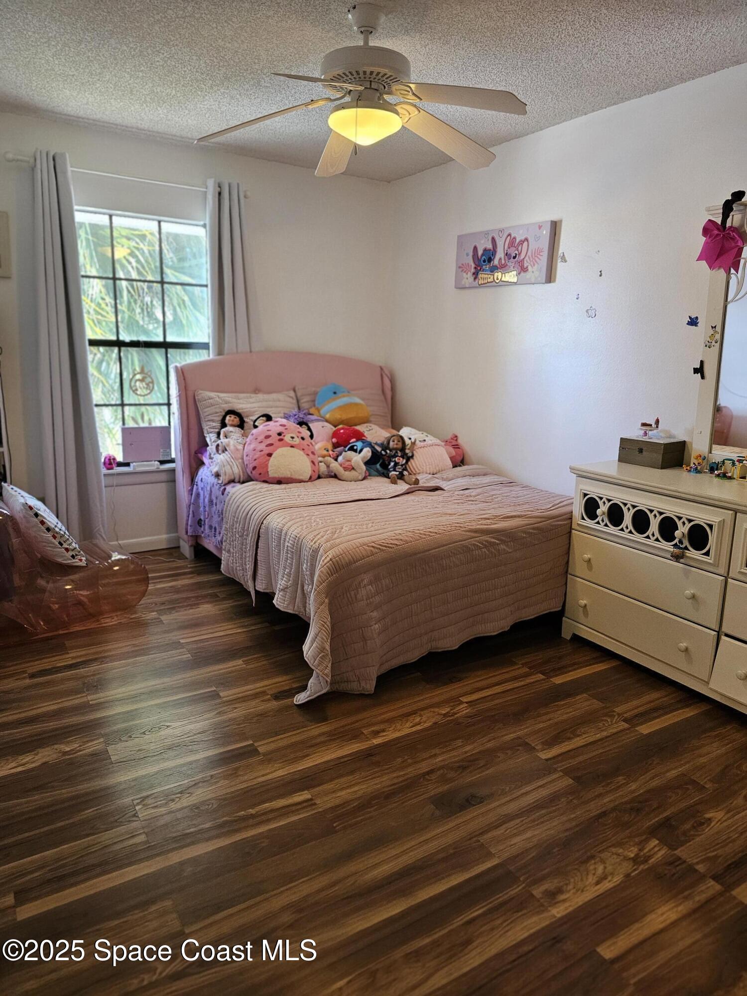 2314 Manor Drive Northeast Palm Bay, FL 32905 - Photo 12 of 23 a bedroom with a bed and a window