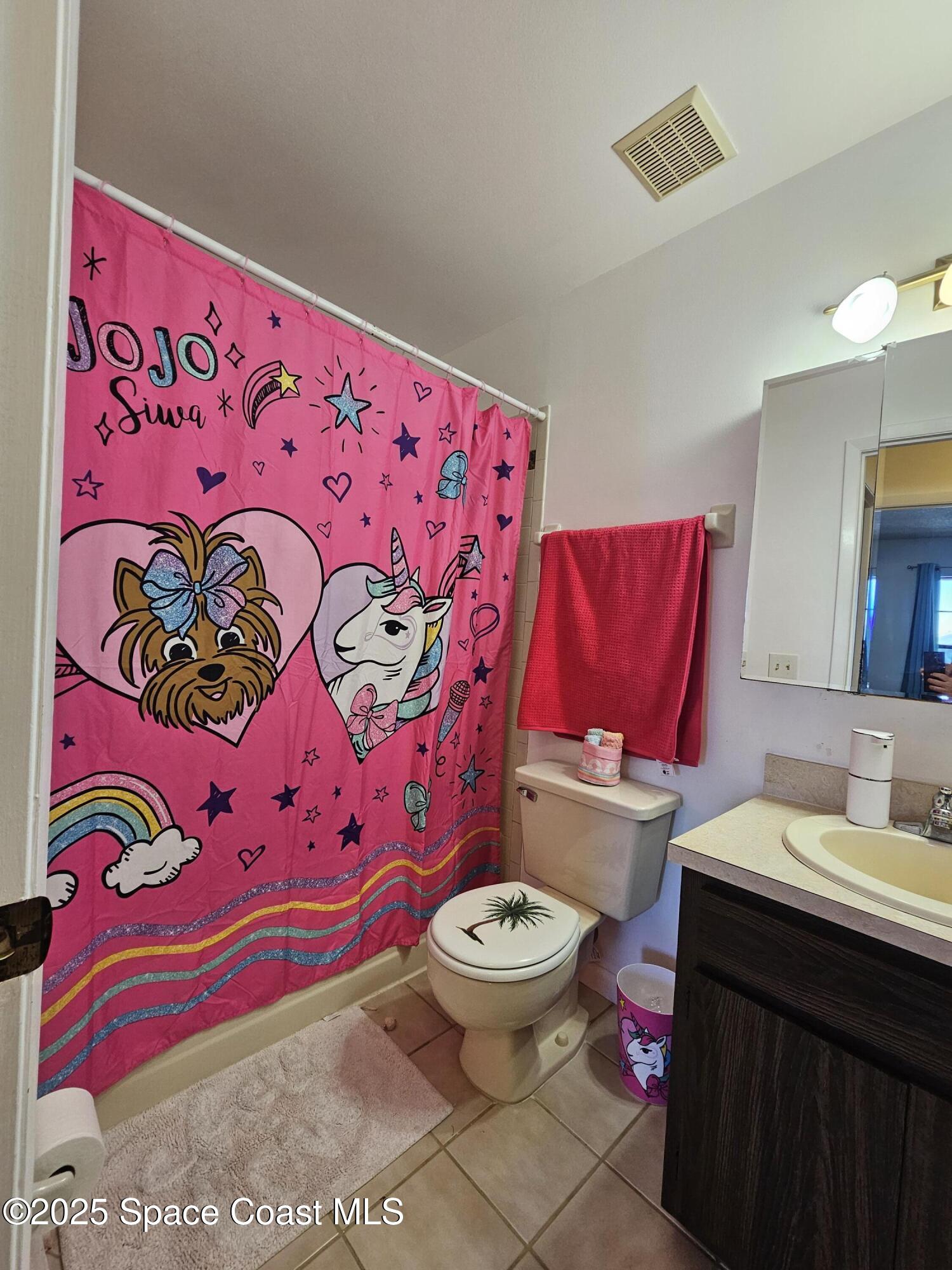 2314 Manor Drive Northeast Palm Bay, FL 32905 - Photo 13 of 23 a bathroom with a toilet and a sink