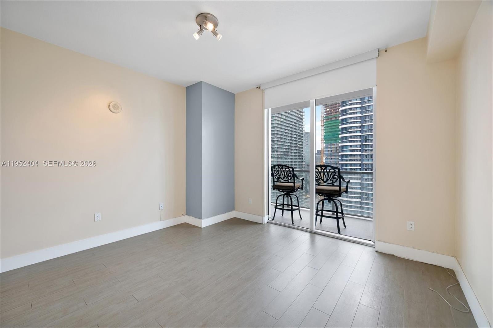 79 Southwest 12th Street, Unit 4004S Miami, FL 33130 - Photo 11 of 29 an empty room with wooden floor and windows