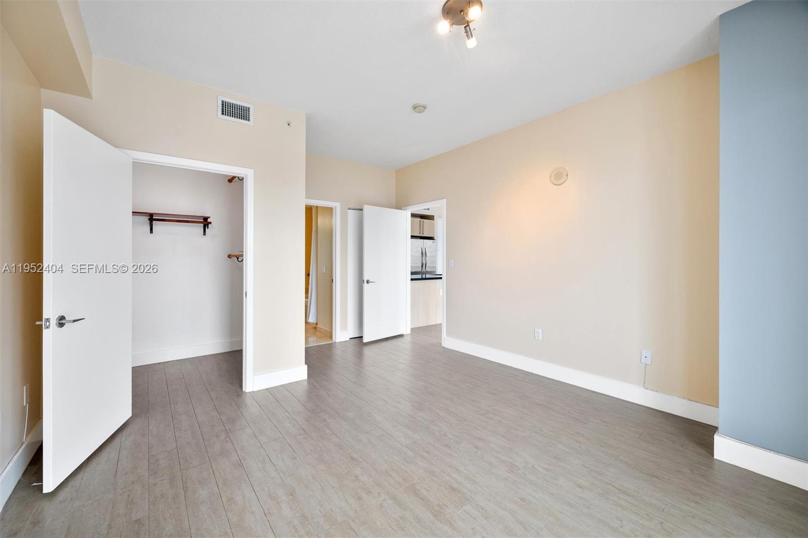 79 Southwest 12th Street, Unit 4004S Miami, FL 33130 - Photo 13 of 29 a view of an empty room with wooden floor and a window