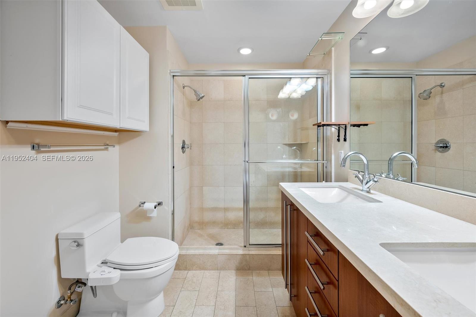 79 Southwest 12th Street, Unit 4004S Miami, FL 33130 - Photo 17 of 29 a bathroom with a sink a toilet and shower