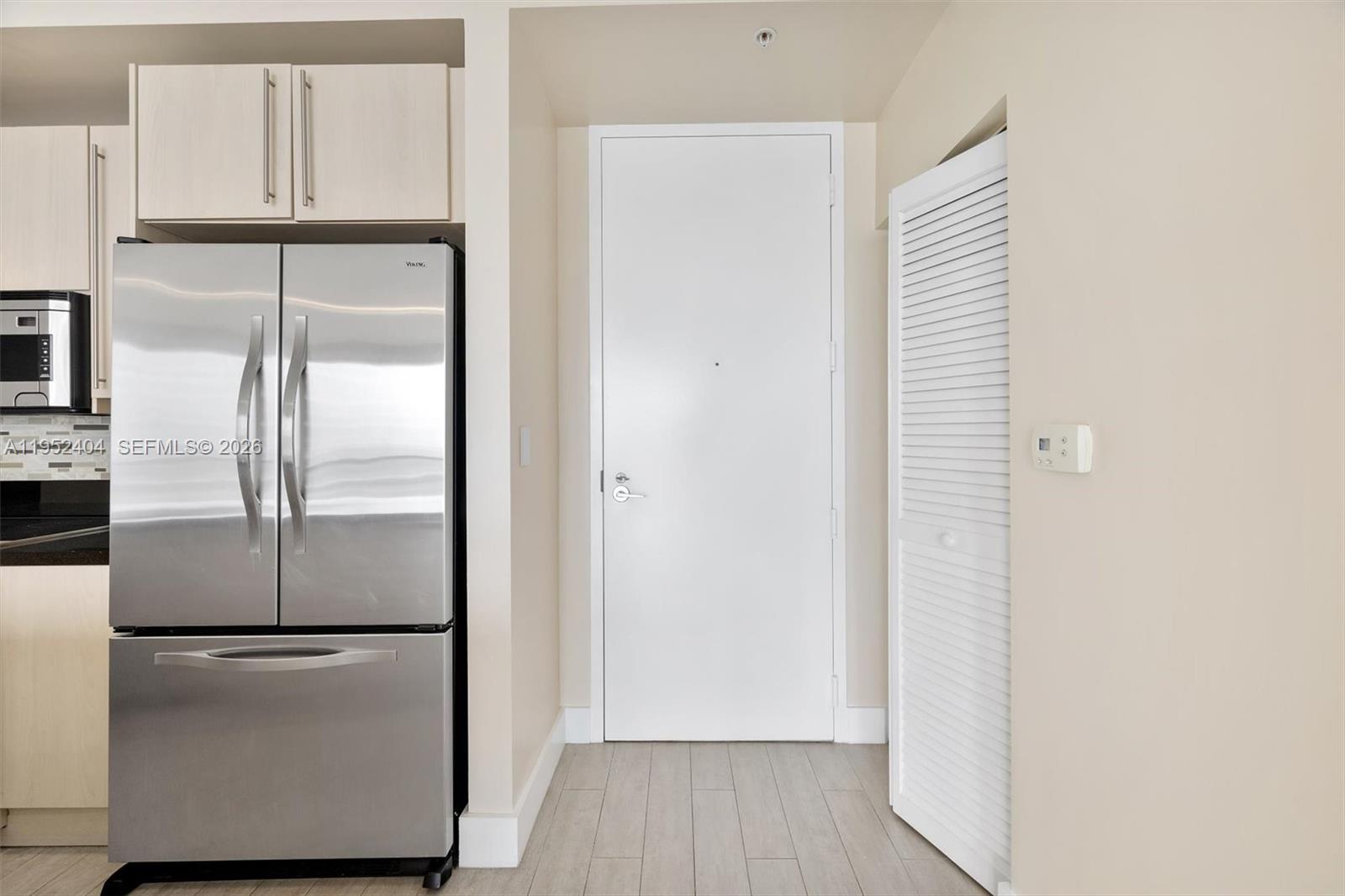 79 Southwest 12th Street, Unit 4004S Miami, FL 33130 - Photo 2 of 29 a kitchen with cabinets and stainless steel appliances