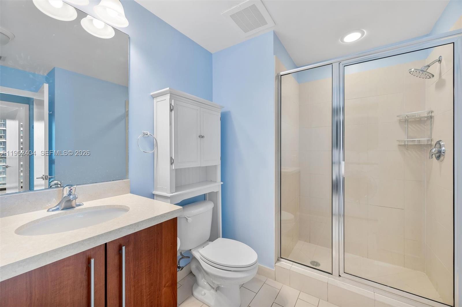 79 Southwest 12th Street, Unit 4004S Miami, FL 33130 - Photo 22 of 29 a bathroom with a granite countertop sink toilet and shower
