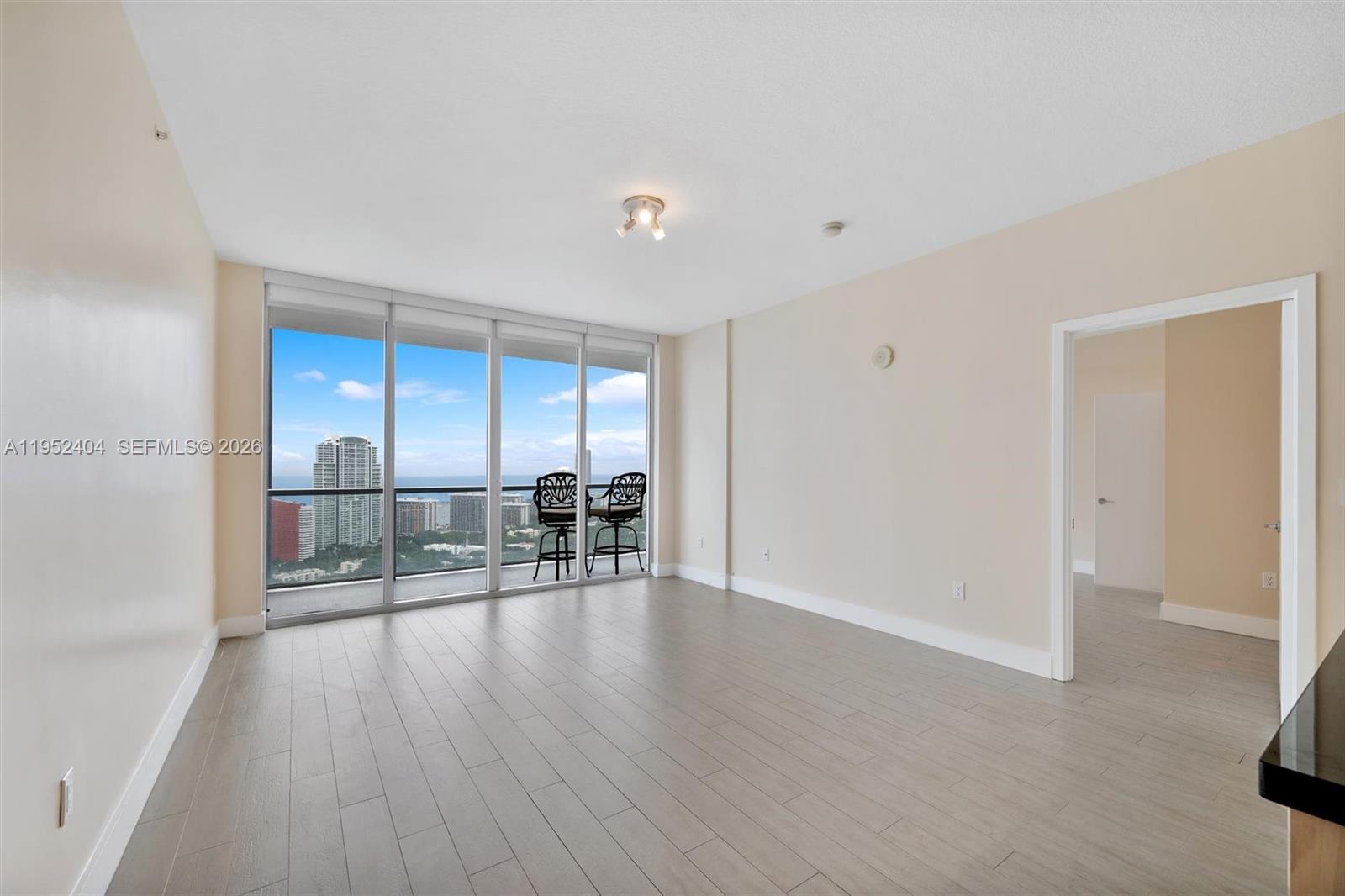 79 Southwest 12th Street, Unit 4004S Miami, FL 33130 - Photo 3 of 29 a view of empty room with wooden floor and fireplace