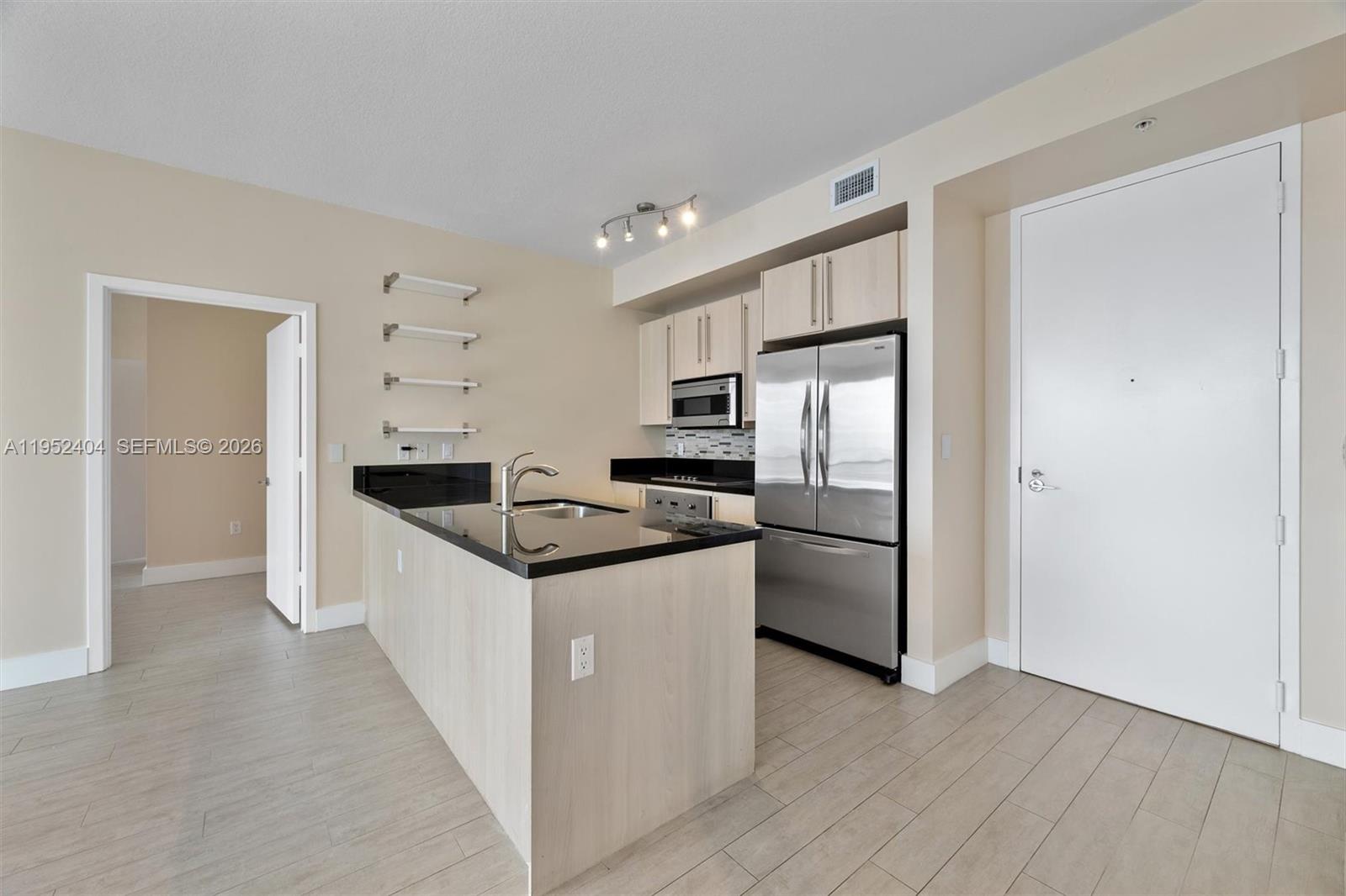 79 Southwest 12th Street, Unit 4004S Miami, FL 33130 - Photo 5 of 29 a kitchen with a refrigerator a sink and dishwasher