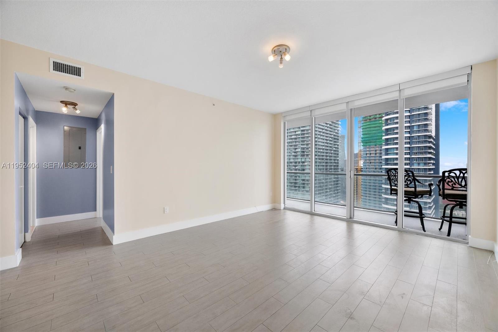 79 Southwest 12th Street, Unit 4004S Miami, FL 33130 - Photo 9 of 29 wooden floor in an empty room with a window