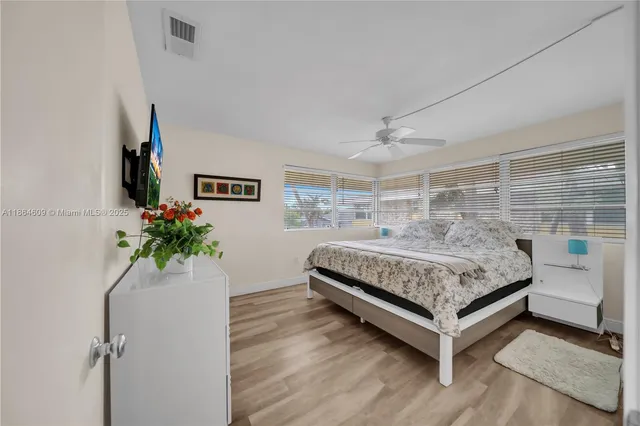 a bedroom with a bed and a potted plant