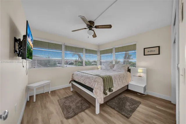 a bedroom with a white bed and white walls