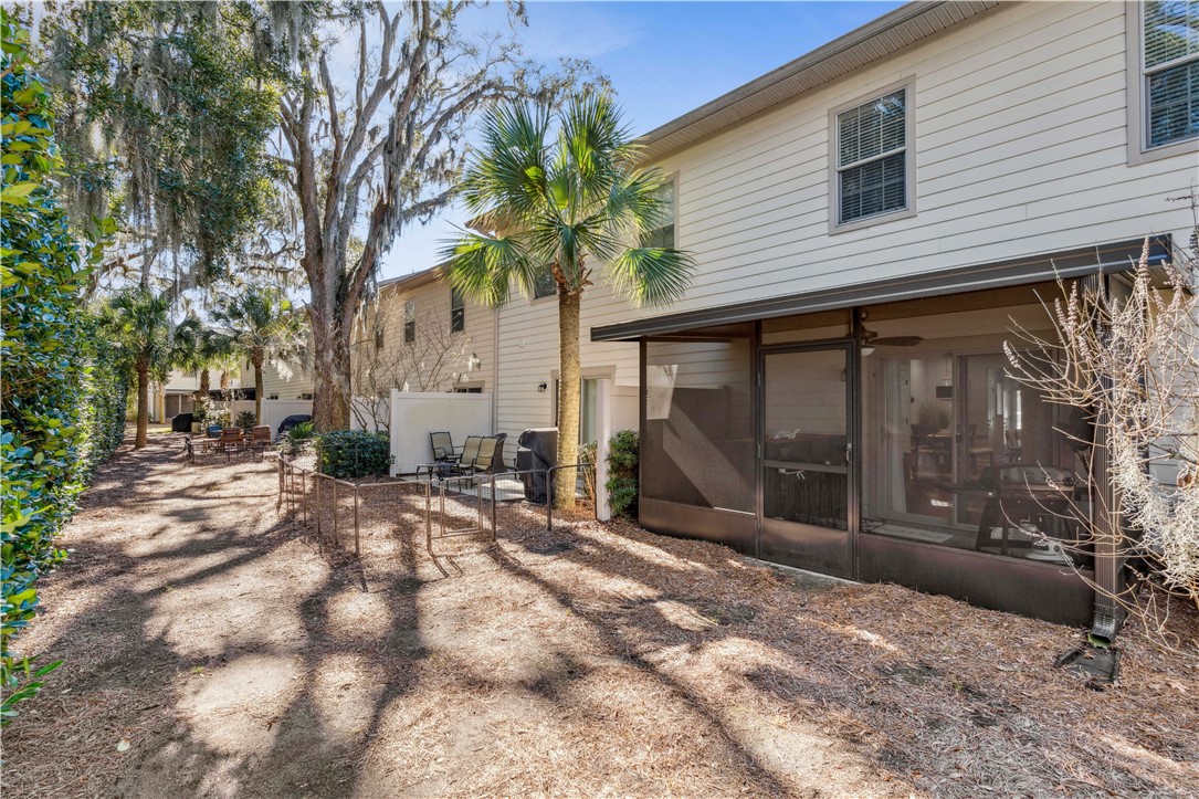 1108 Reserve Lane St. Simons Island, GA 31522 - Photo 16 of 30 Landscaped back yard with fence
