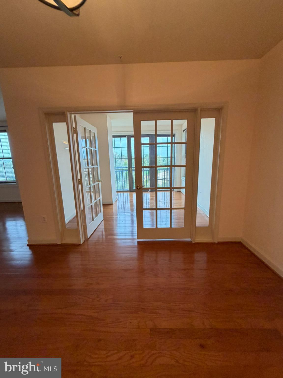 485 Harbor Side Street Woodbridge, VA 22191 - Photo 11 of 28 a view of an empty room with wooden floor and a window