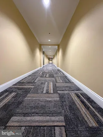 a view of empty room with wooden floor and floor to ceiling window