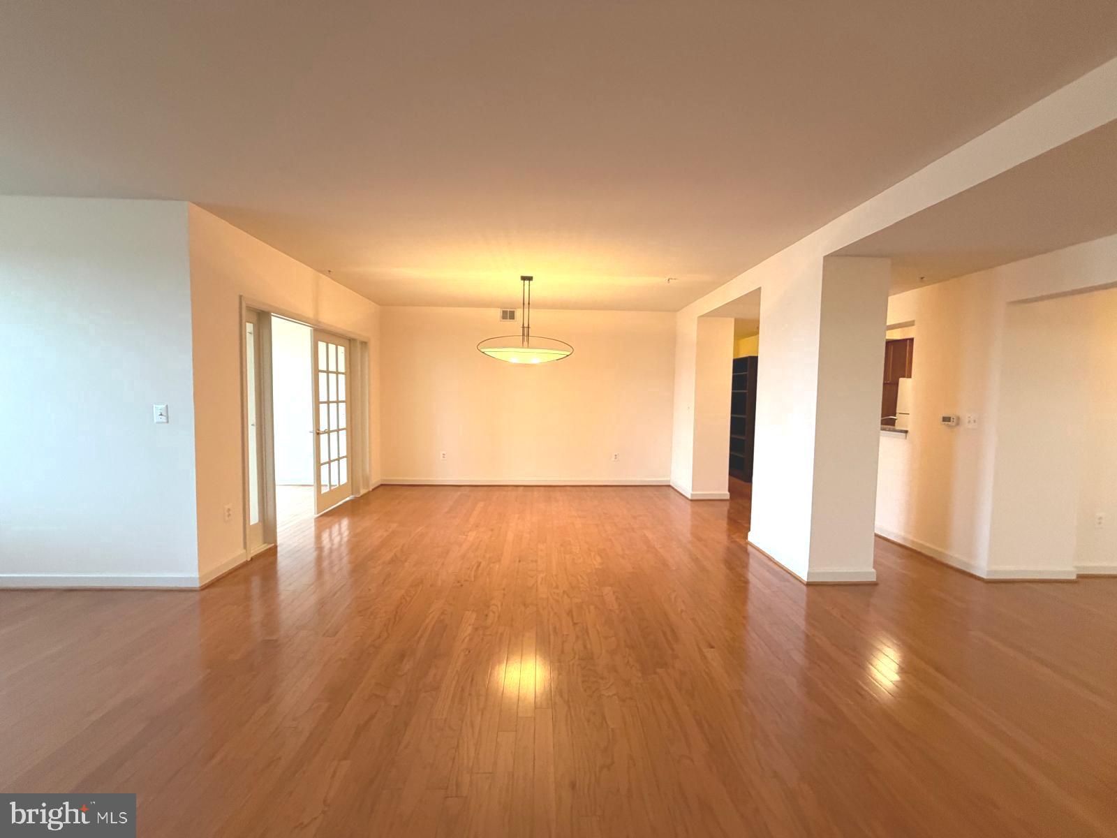 485 Harbor Side Street Woodbridge, VA 22191 - Photo 4 of 28 a view of an empty room with wooden floor and a window