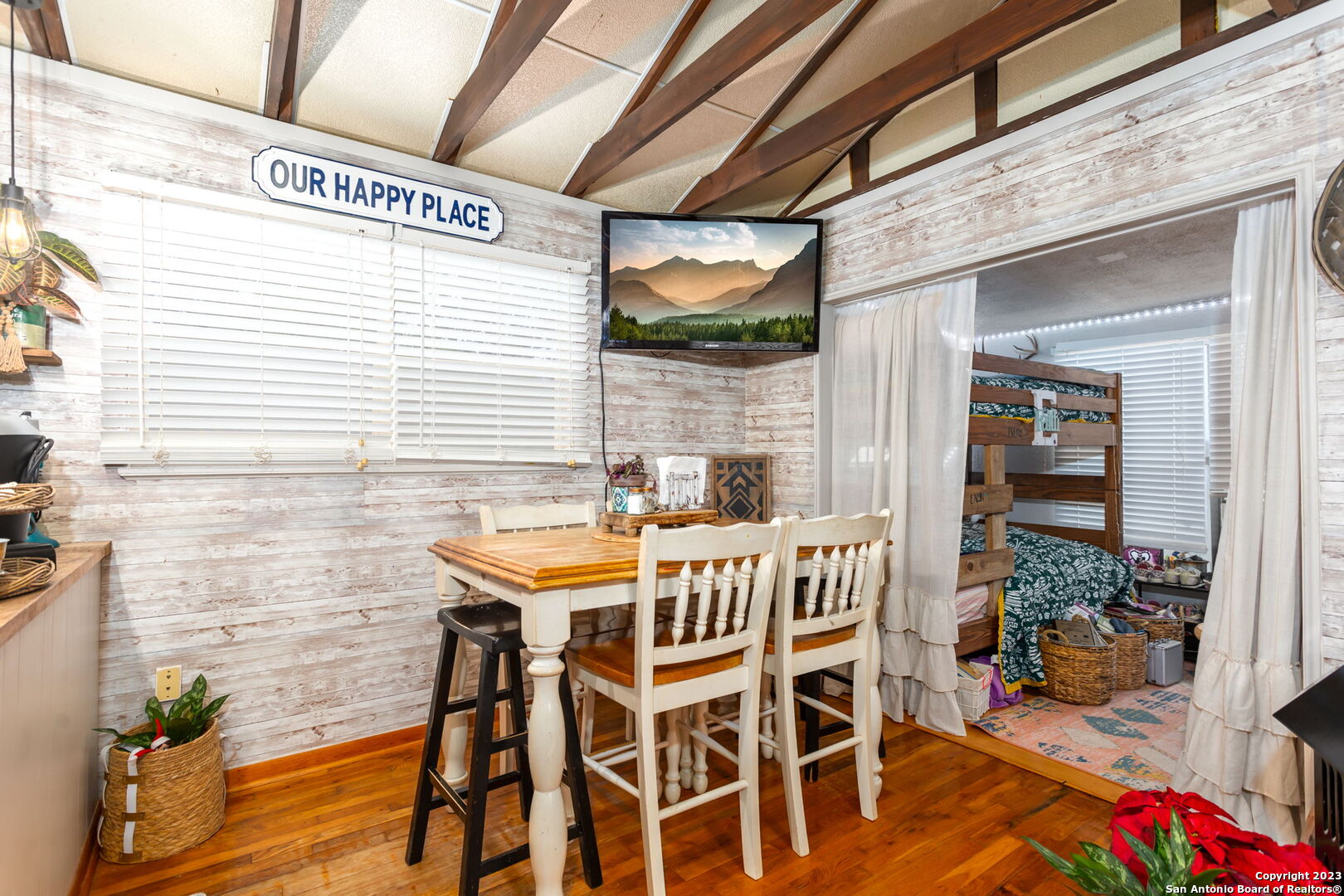 8417 Highway 16 Bandera, TX 78003 - Photo 15 of 28 a view of a patio with table and chairs with wooden floor and fence