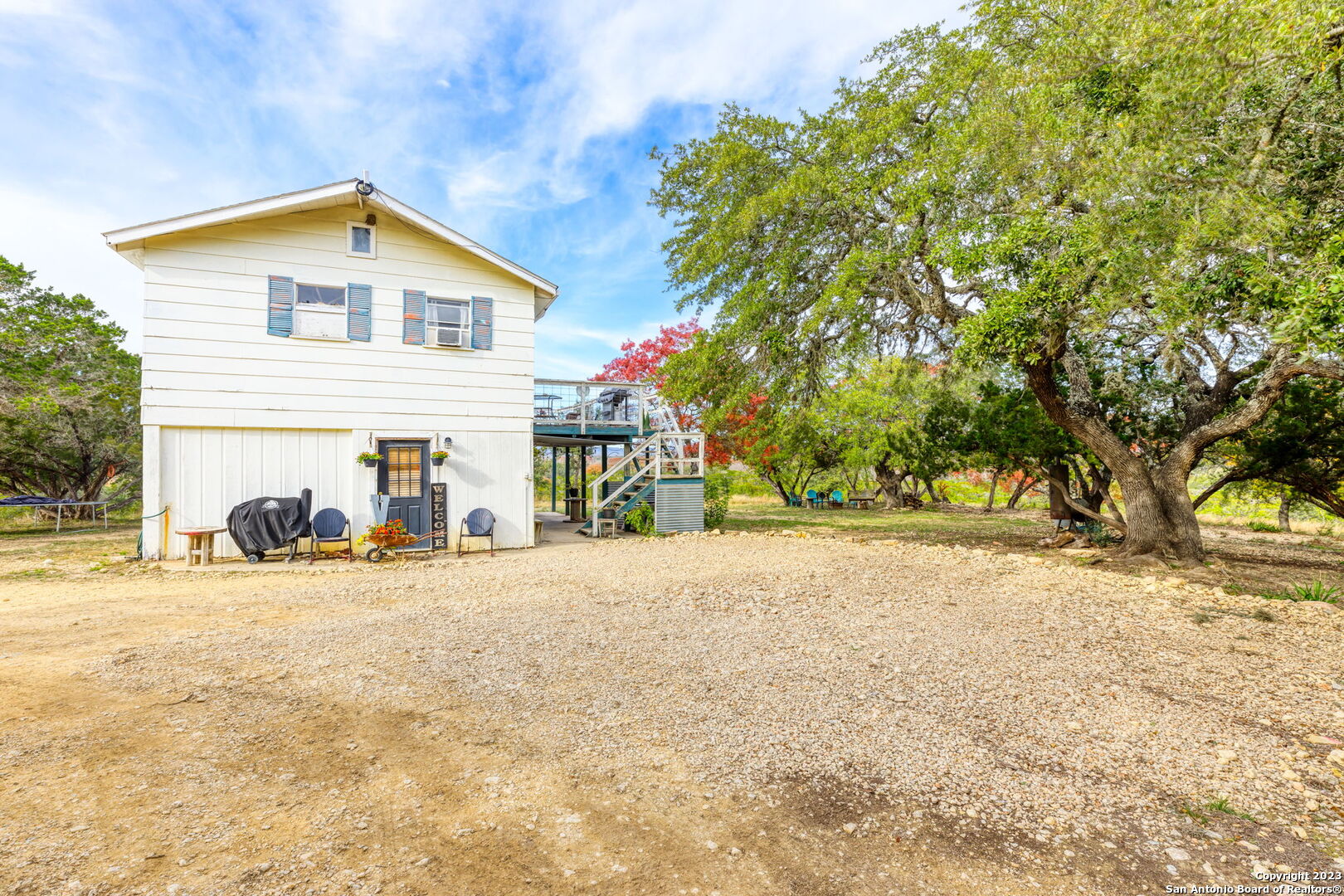 8417 Highway 16 Bandera, TX 78003 - Photo 20 of 28 a view of a house with a yard and large trees