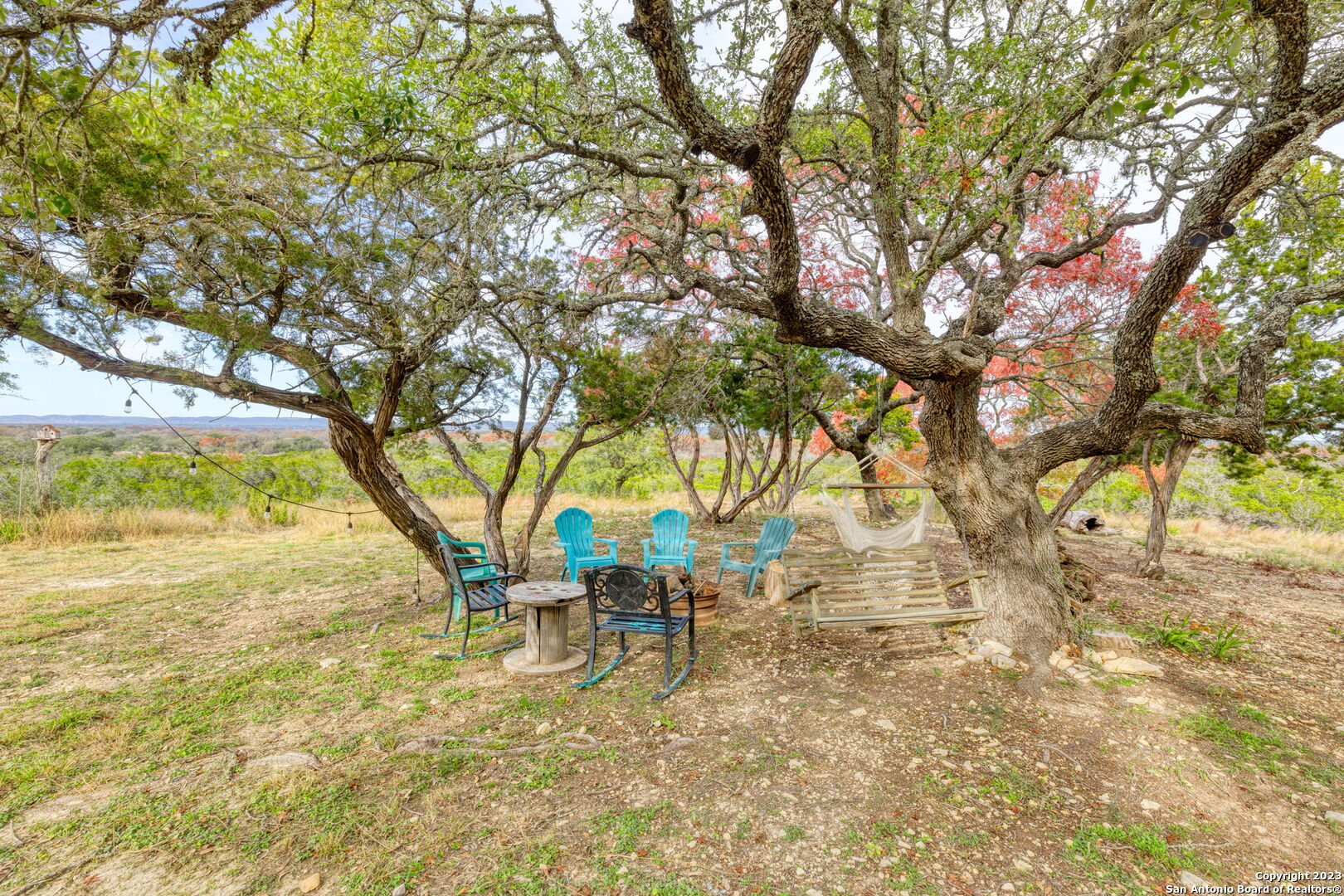 8417 Highway 16 Bandera, TX 78003 - Photo 22 of 28 a backyard of a house with table and chairs
