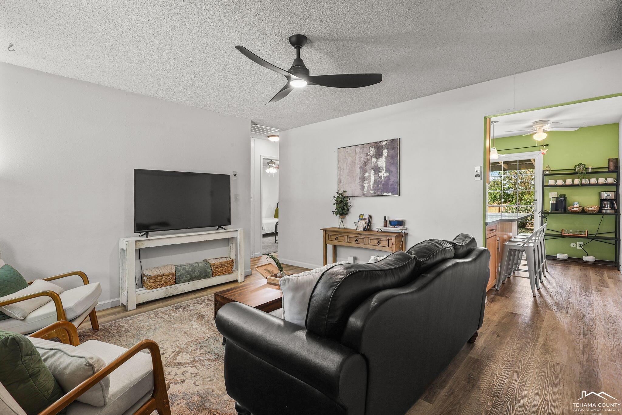 22275 Brent Road Red Bluff, CA 96080 - Photo 5 of 47 a living room with furniture and a flat screen tv