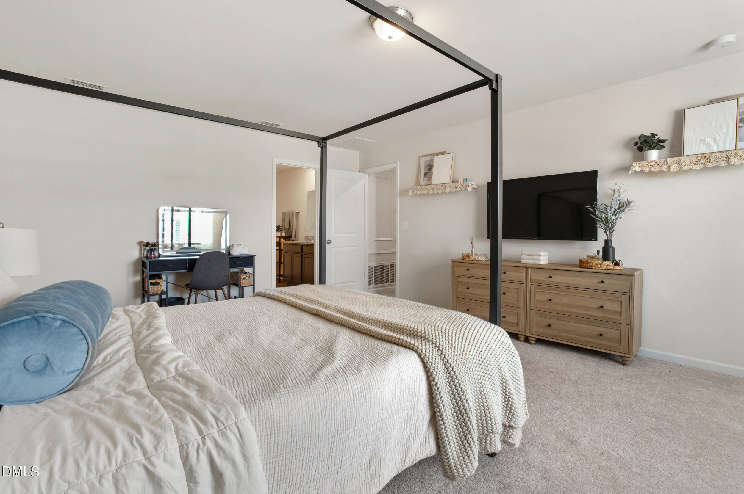 1416 Heron Pond Street Raleigh, NC 27604 - Photo 17 of 25 a bedroom with a bed and tv on the dresser