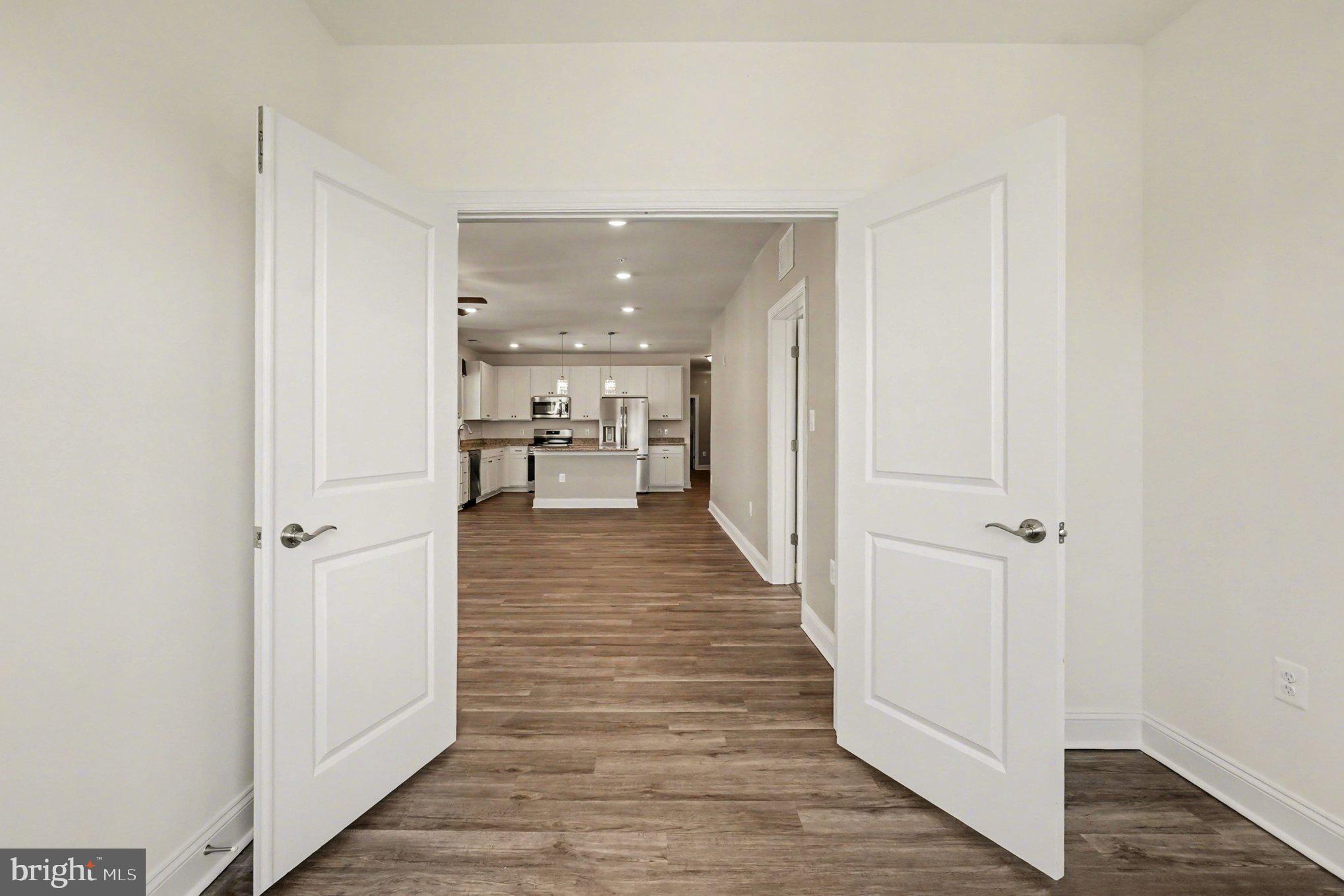 406 Bold Ruler Court, Unit 402 Havre de Grace, MD 21078 - Photo 16 of 59 a hallway with wooden floor and staircase
