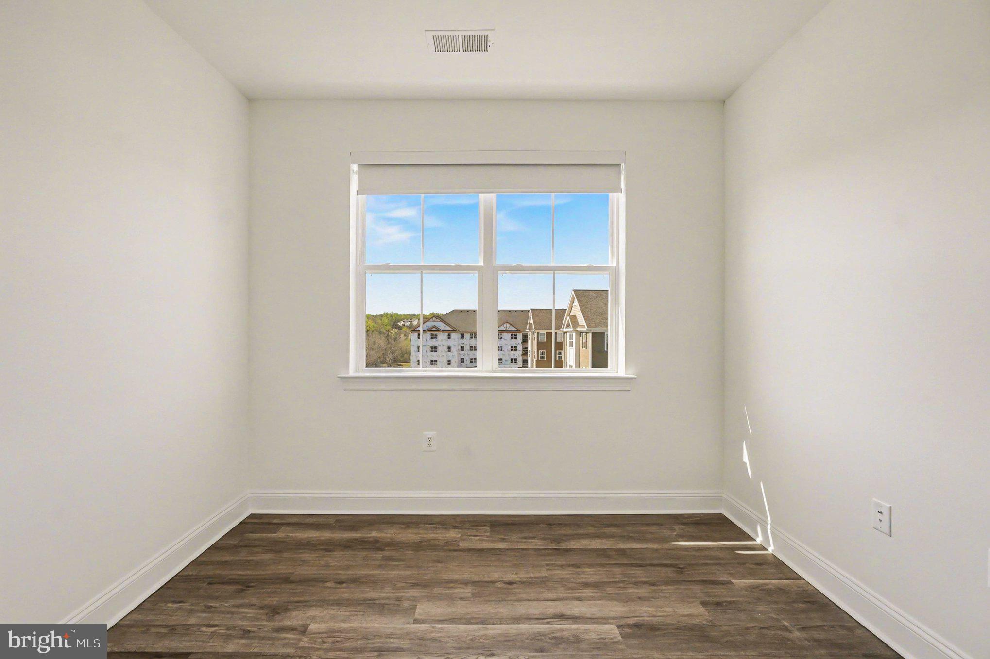 406 Bold Ruler Court, Unit 402 Havre de Grace, MD 21078 - Photo 17 of 59 a view of an empty room with wooden floor and a window