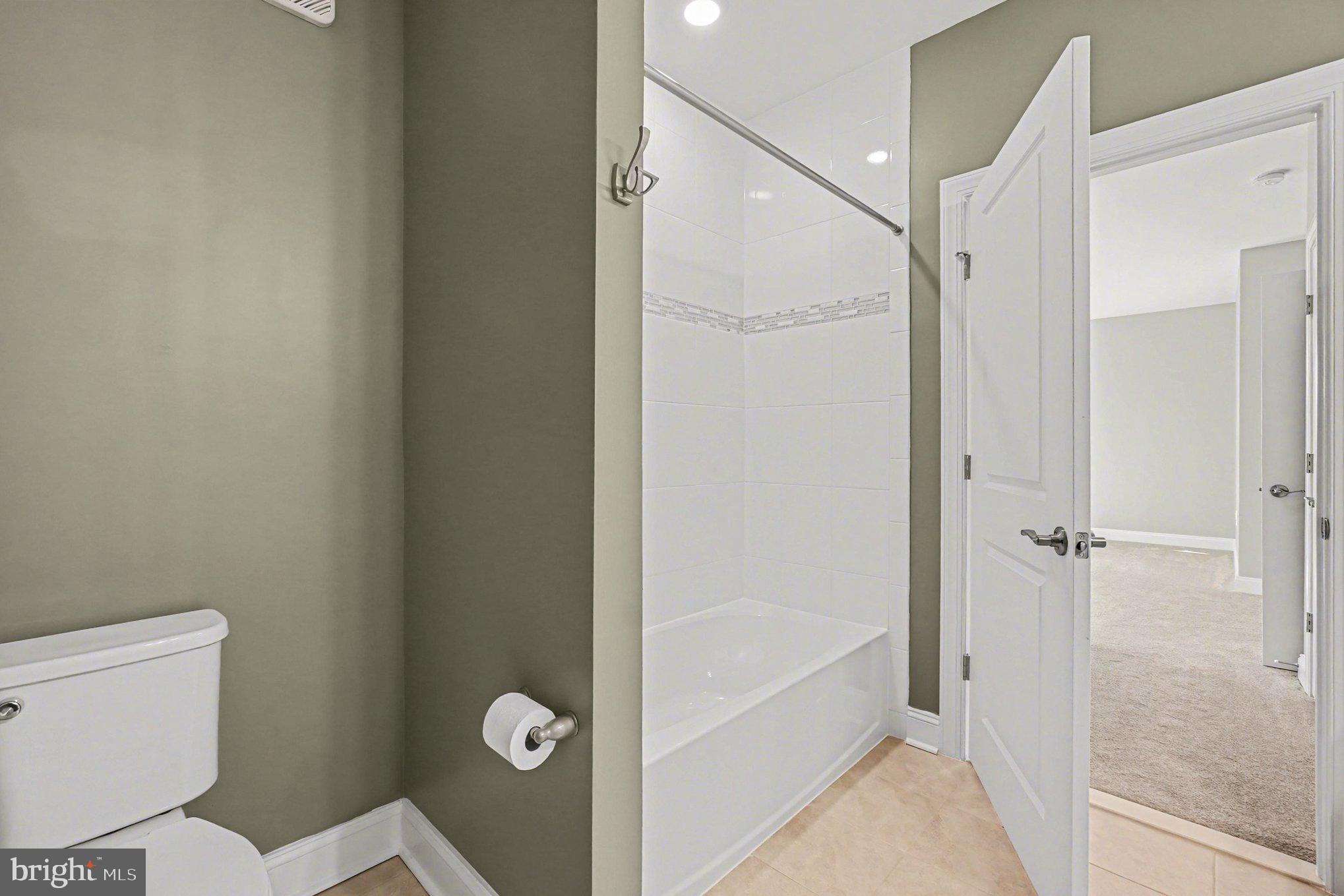 406 Bold Ruler Court, Unit 402 Havre de Grace, MD 21078 - Photo 21 of 59 a bathroom with a granite countertop bathtub and toilet