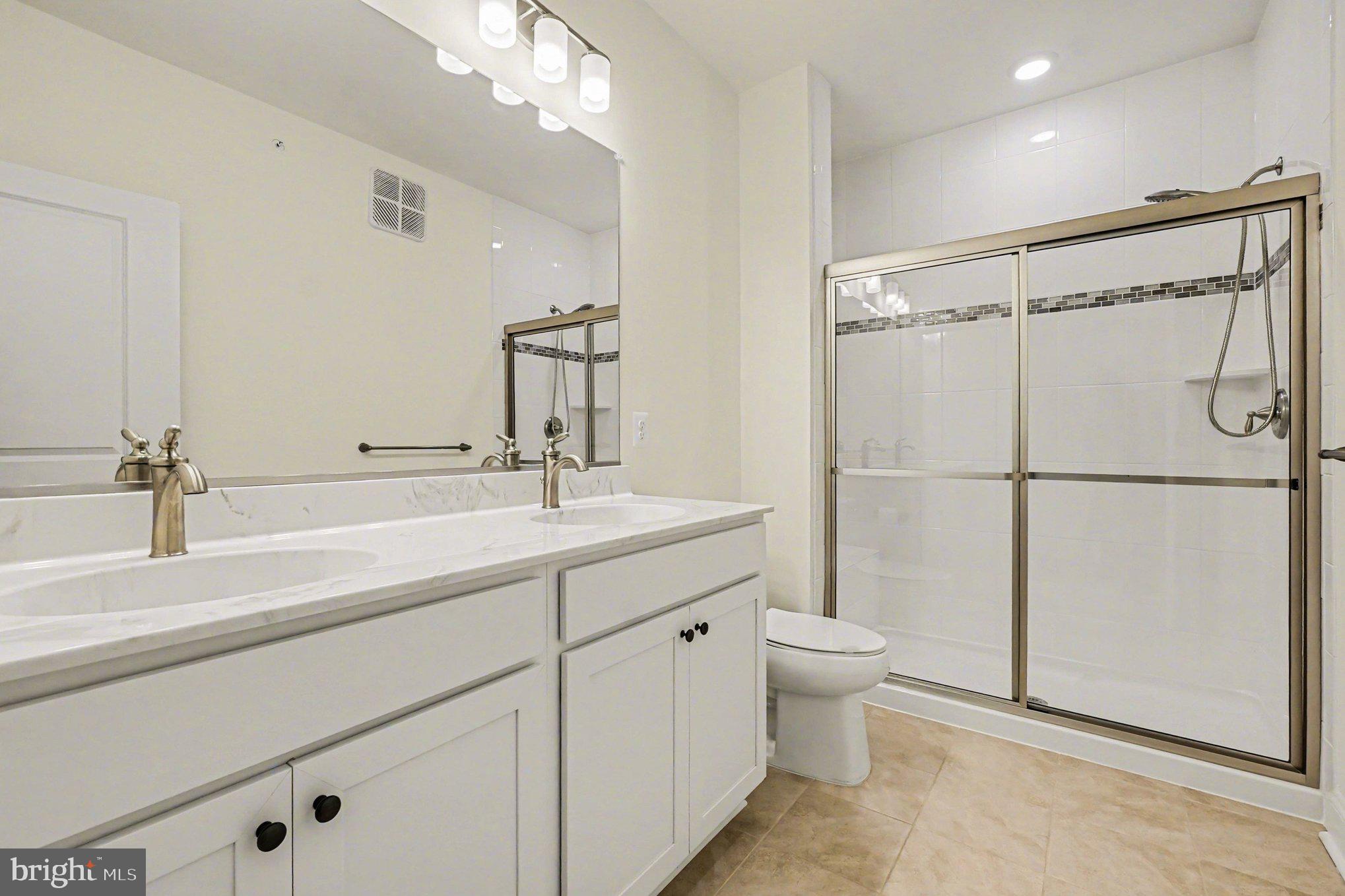 406 Bold Ruler Court, Unit 402 Havre de Grace, MD 21078 - Photo 25 of 59 a spacious bathroom with a double vanity sink mirror and toilet