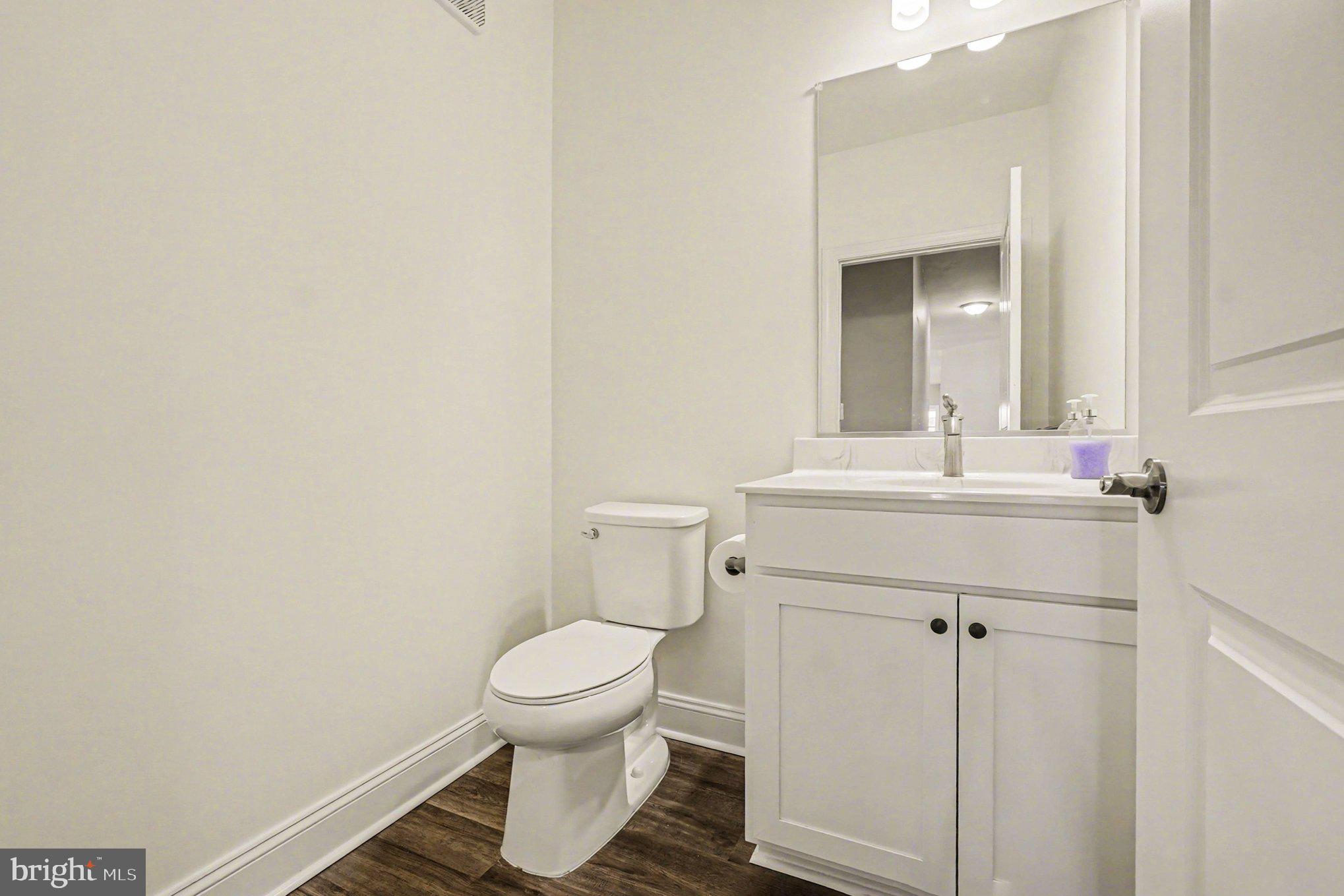 406 Bold Ruler Court, Unit 402 Havre de Grace, MD 21078 - Photo 26 of 59 a bathroom with a sink toilet and mirror