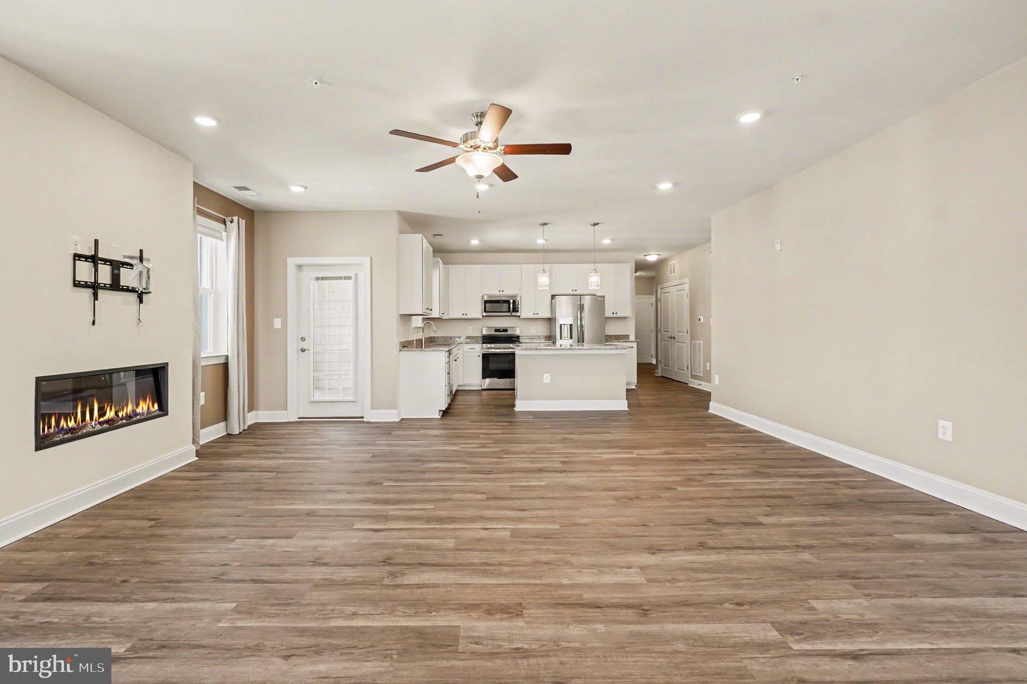 406 Bold Ruler Court, Unit 402 Havre de Grace, MD 21078 - Photo 7 of 59 a view of a kitchen with a sink a fireplace and a window