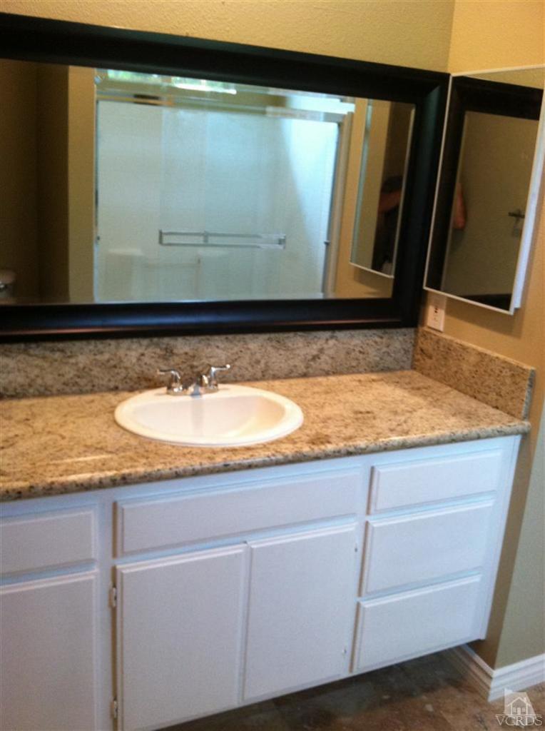 4249 Rusticview Court Moorpark, CA 93021 - Photo 5 of 7 a sink with a mirror