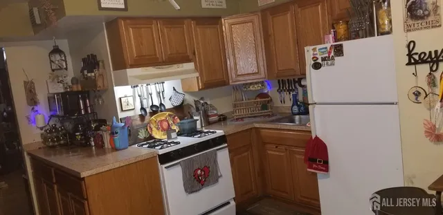 a kitchen with a refrigerator and a stove