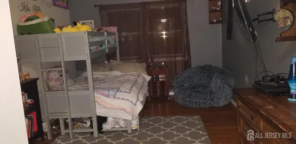 a bedroom with furniture and a mirror