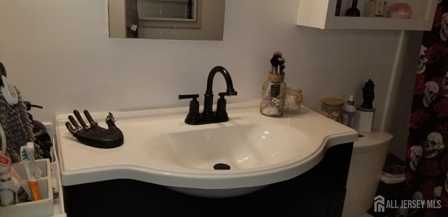 30 Judson Street, Unit 6A Edison, NJ 08837 - Photo 9 of 14 a bathroom with a sink and a mirror