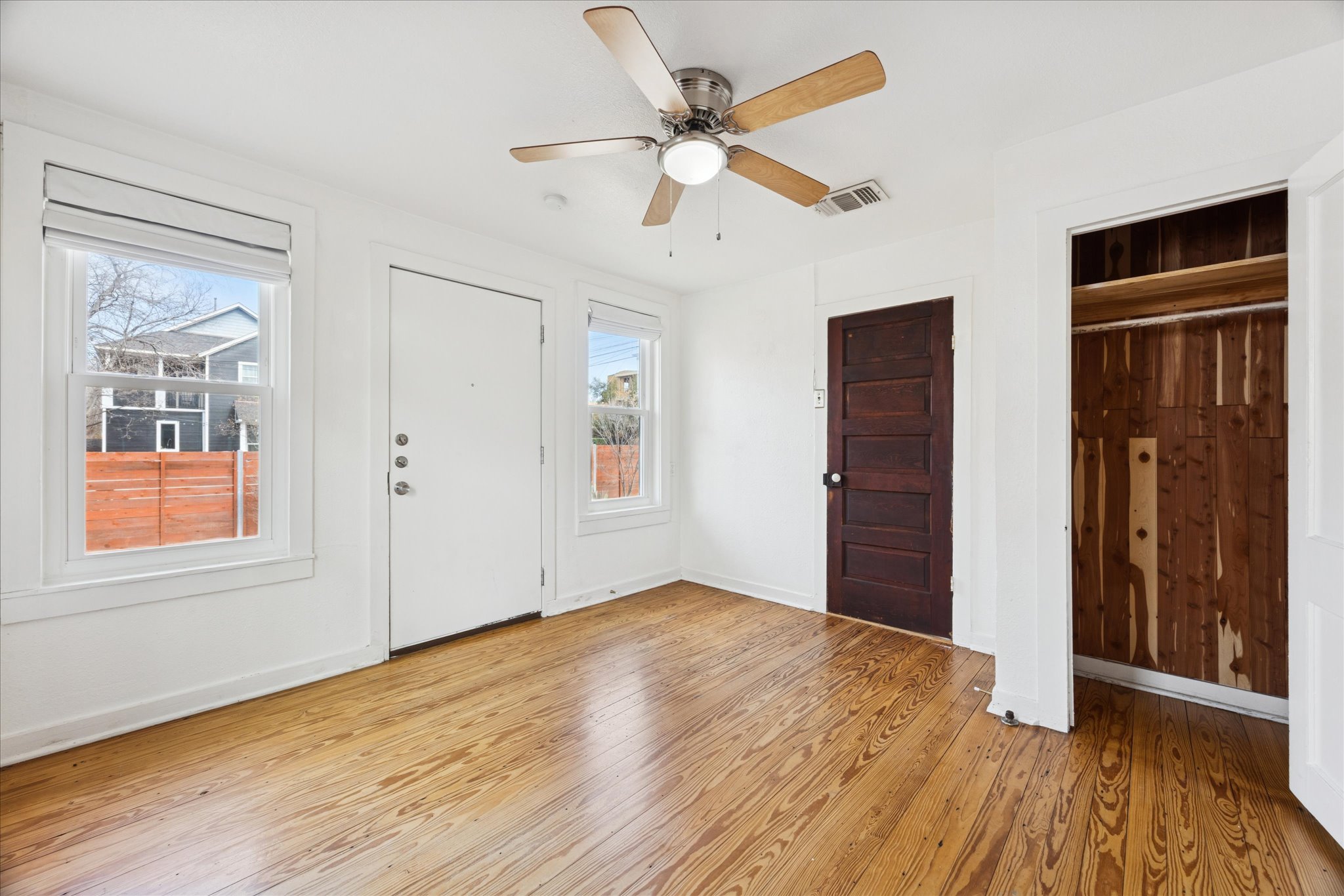 1210 Coleto Street Austin, TX 78702 - Photo 12 of 22 a view of an empty room with wooden floor and a window