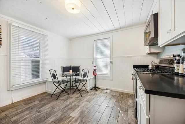 a dining room with furniture and wooden floor