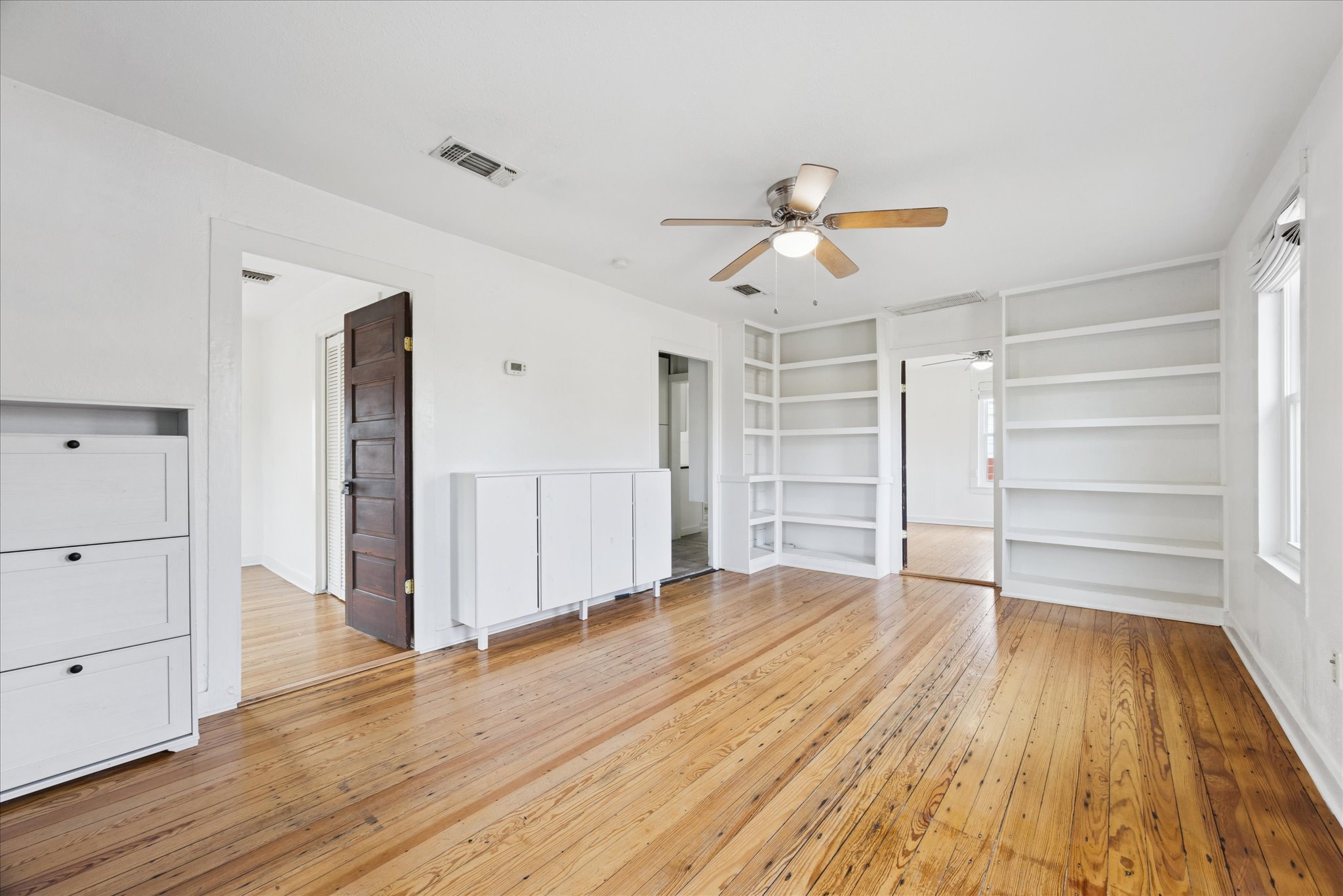 1210 Coleto Street Austin, TX 78702 - Photo 2 of 22 a view of a room with wooden floor and ceiling fan