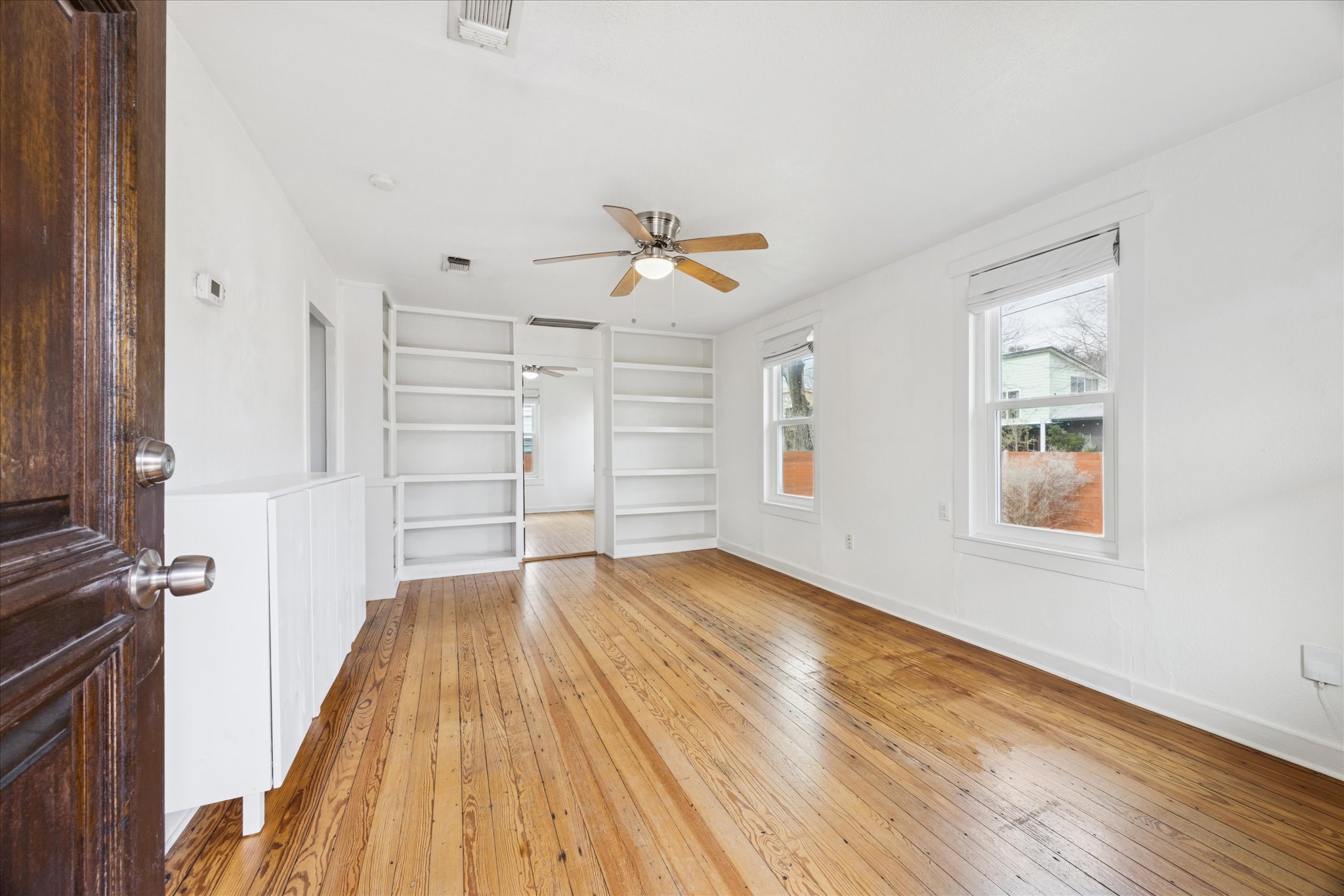 1210 Coleto Street Austin, TX 78702 - Photo 4 of 22 wooden floor in an empty room with a window
