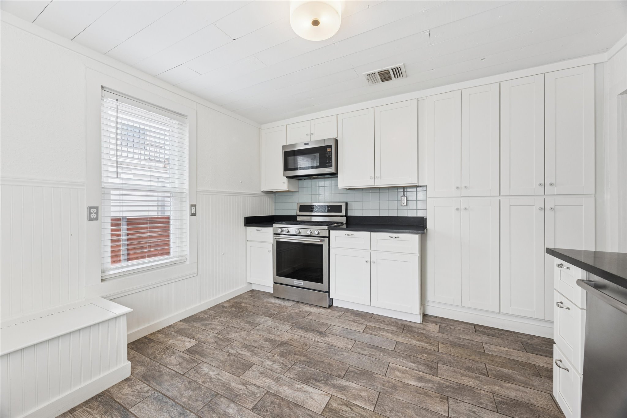 1210 Coleto Street Austin, TX 78702 - Photo 6 of 22 a kitchen with granite countertop white cabinets and appliances