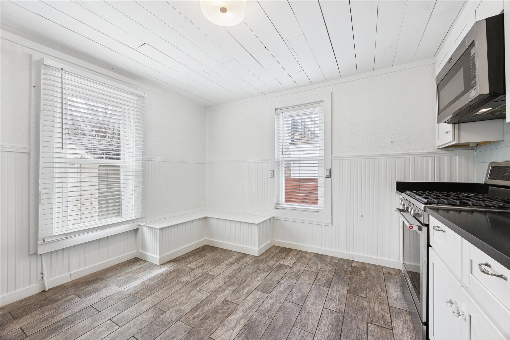 1210 Coleto Street Austin, TX 78702 - Photo 7 of 22 a kitchen with granite countertop a stove a sink and a microwave